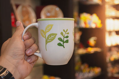 Close-up of woman holding coffee cup