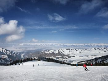 People skiing on snow covered mountain