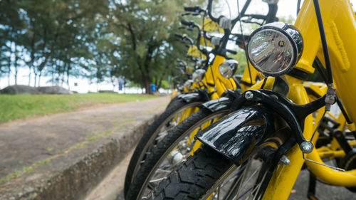 Close-up of yellow motorcycle on field