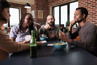 Friends playing cards at home