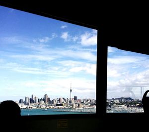 View of cityscape against cloudy sky