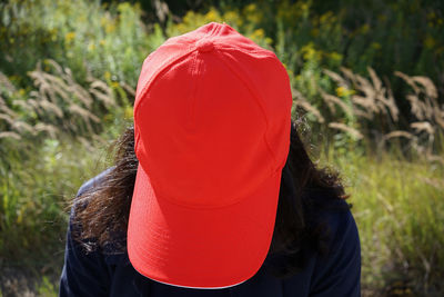 Rear view of woman wearing hat on field