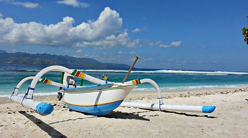 Scenic view of beach against blue sky