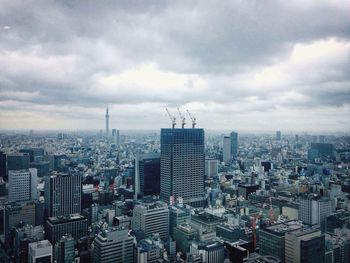 Cityscape against cloudy sky