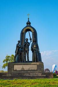 Low angle view of statue against blue sky