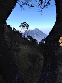 Scenic view of mountains against blue sky