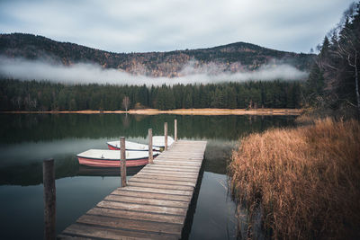 Pier over lake against sky