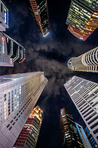 Low angle view of buildings against cloudy sky