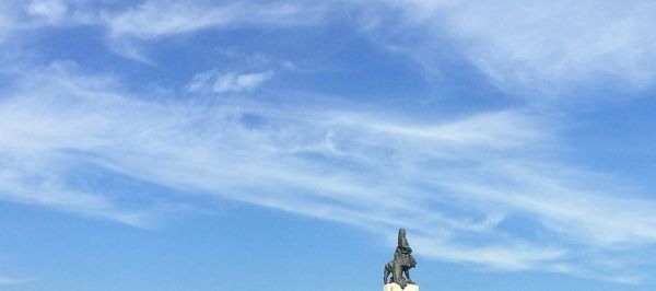 Low angle view of statue against sky