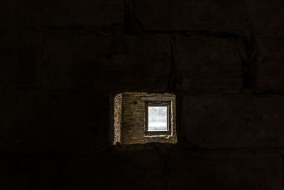 Low angle view of window in abandoned building
