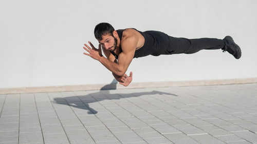 Full length of muscular man exercising