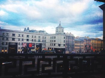 Buildings against cloudy sky