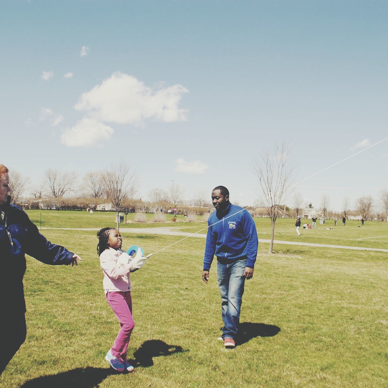 grass, childhood, lifestyles, leisure activity, girls, boys, casual clothing, elementary age, field, full length, grassy, togetherness, innocence, person, playing, sky, playful, park - man made space, bonding