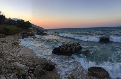 Scenic view of seascape against clear sky during sunset