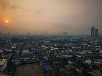 High angle view of buildings in city against sky during sunset