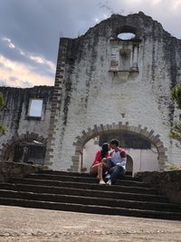 People sitting on staircase of building