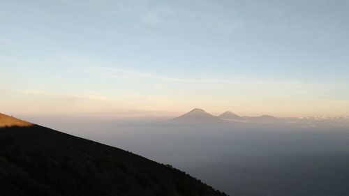 Scenic view of mountain against cloudy sky