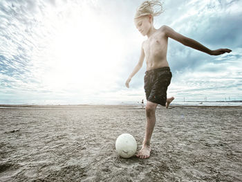 Full length of woman ball on beach