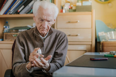 Man sitting on table at home