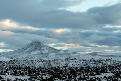 Scenic view of snow covered mountains against sky