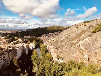 Panoramic view of trees and buildings against sky