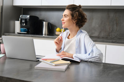 Young businesswoman working at desk in office