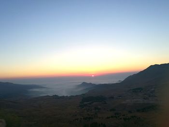 Scenic view of silhouette mountains against sky during sunset