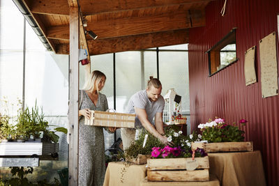 Couple choosing flowers in shop