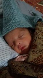 Close-up of baby sleeping on bed