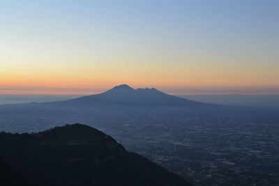 Scenic view of silhouette mountains against sky during sunset