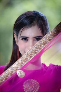 Portrait of smiling young woman wearing traditional clothing