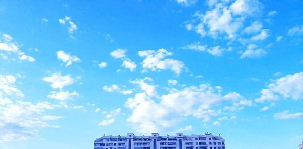 Low angle view of building against cloudy sky