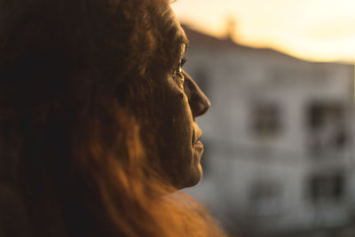 Close-up portrait of young man looking away outdoors