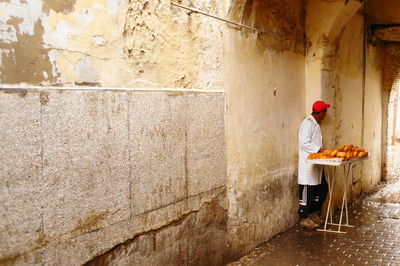 Full length of man working on wall