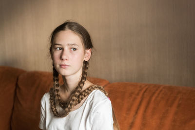 Portrait of young woman standing at home