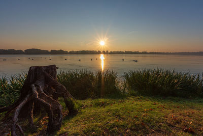 Scenic view of lake against sky during sunset