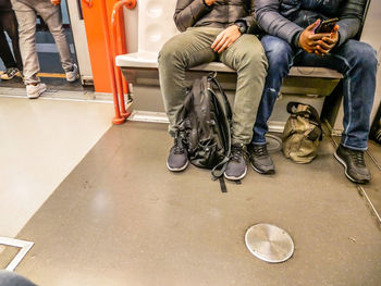 Low section of people sitting in train