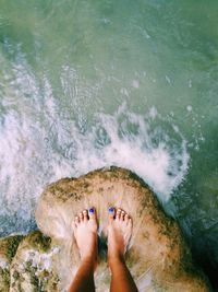 Low section of woman standing on beach