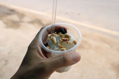 Midsection of person holding bowl