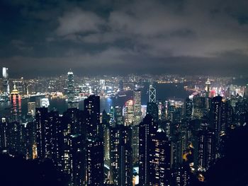 Illuminated cityscape against sky at night