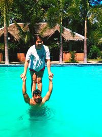 Portrait of young couple in swimming pool