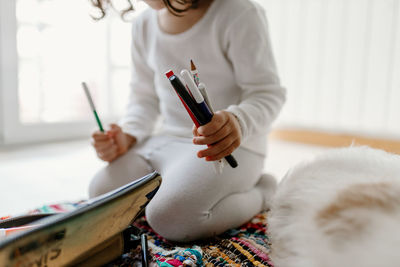 Midsection of woman working at home