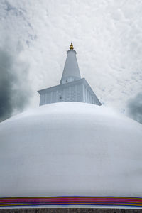 Traditional building against sky during winter