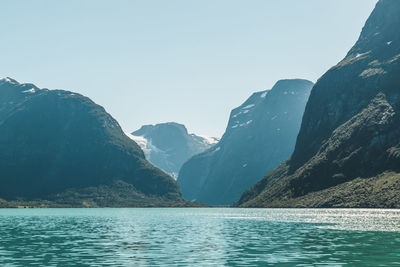 Scenic view of lake and mountains against clear sky