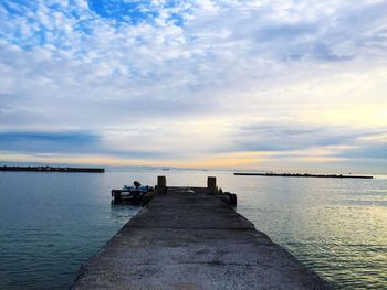 Scenic view of calm sea against cloudy sky