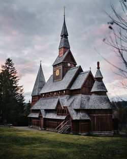 Exterior of church building on field against sky