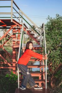 Portrait of girl standing against plants