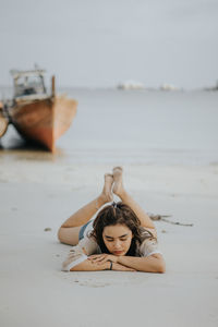Portrait of woman lying on beach