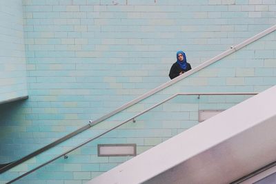 Full length of woman standing on railing