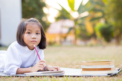 Portrait of a smiling girl sitting on table